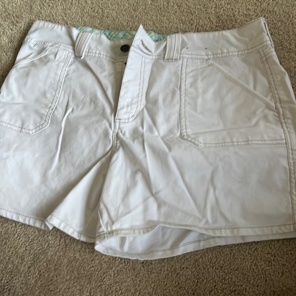 white shorts with stitch detail and green detail inside